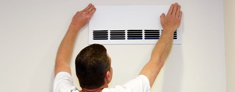 man covering his air flow ducts with tape