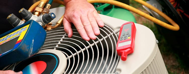 technician fixing air conditioner